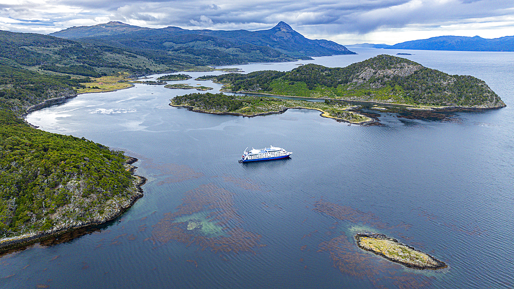 Aerial of a cruise ship anchoring in Wulaia Bay, Tierra del Fuego, Chile, South America