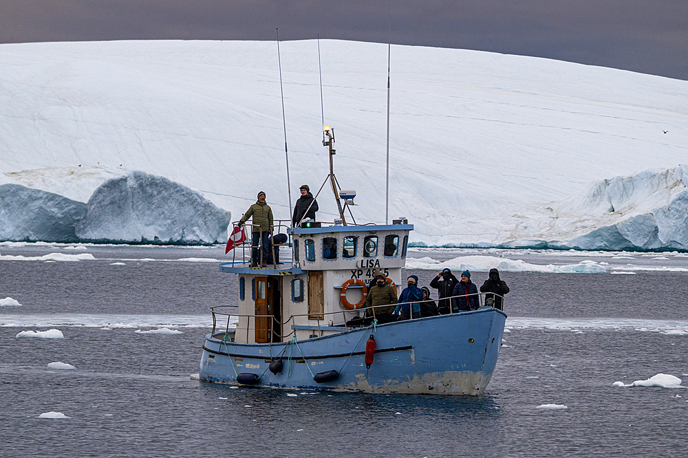 Little boat between the icebergs of the Ilulissat Icefjord, UNESCO World Heritage Site, Western Greenland, Denmark, Polar Regions