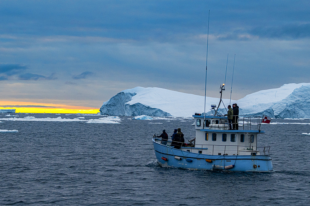 Little boat between the icebergs of the Ilulissat Icefjord, UNESCO World Heritage Site, Western Greenland, Denmark, Polar Regions