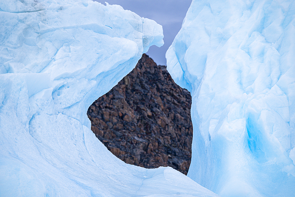 Hole in an iceberg, Belcher island, Devon island, Nunavut, Canadian Arctic, Canada, North America