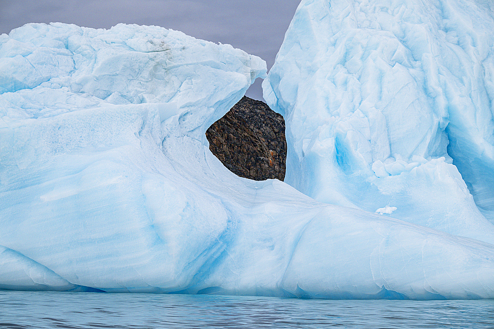 Hole in an iceberg, Belcher island, Devon island, Nunavut, Canadian Arctic, Canada, North America