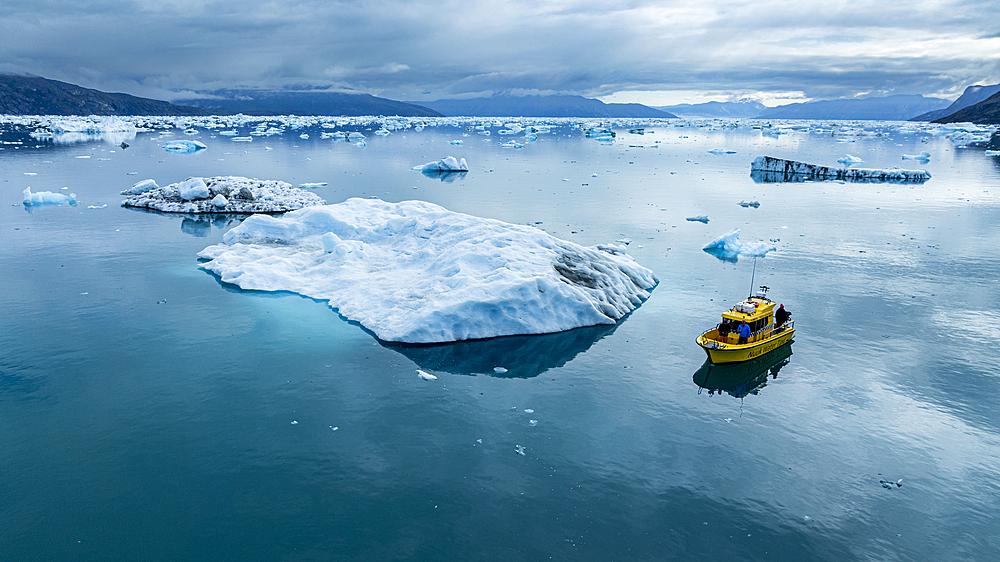 Aerial of a little boat anchoring in the Nuuk Icefjord, Western Greenland, Denmark, Polar Regions