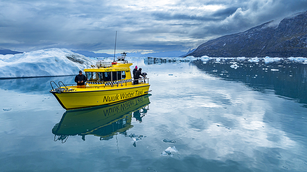 Aerial of a little boat anchoring in the Nuuk Icefjord, Western Greenland, Denmark, Polar Regions