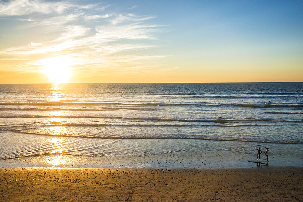 Couple in backlight walking at sunset, Del Mar, California, United States of America, North America