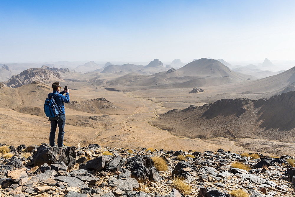 Man enjoying the mounains of Assekrem, Tamanrasset, Hoggar mountains, Algeria, North Africa, Africa