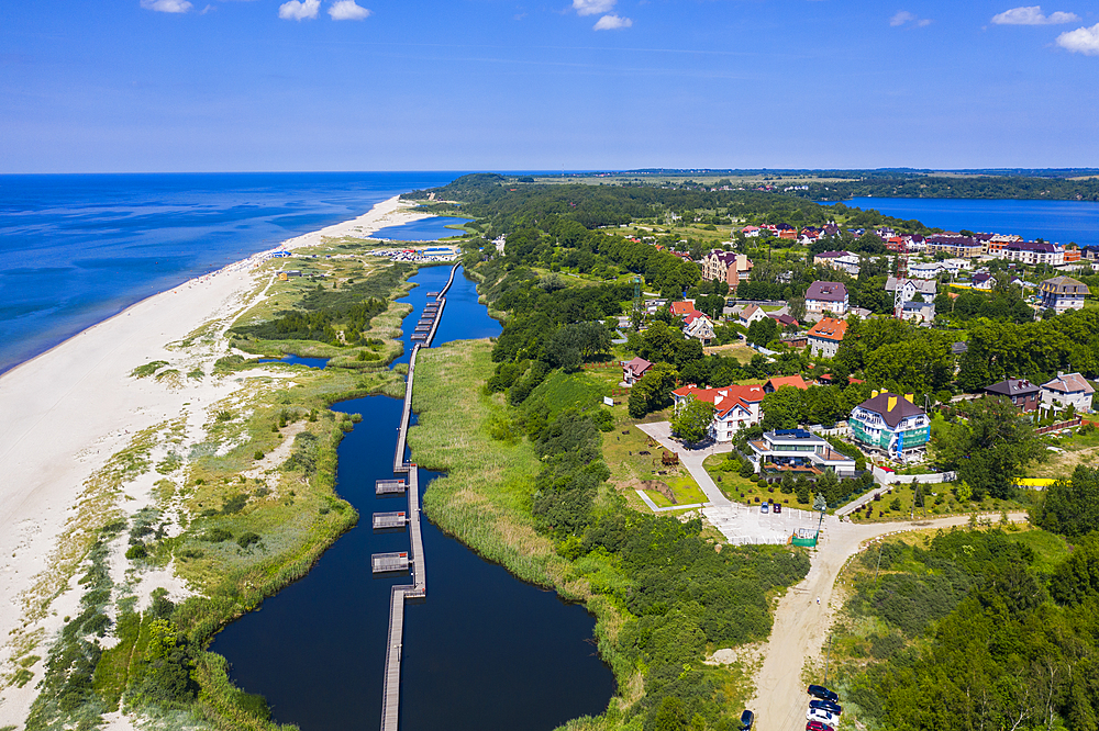 Aerial by drone of a boardwalk in a little lake on the coast of Yantarny, Kaliningrad, Russia, Europe