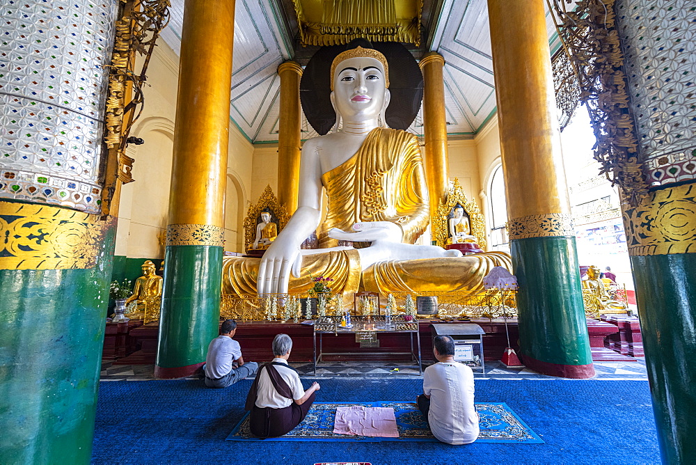 Pilgrims praying in the Shwedagon pagoda, Yangon (Rangoon), Myanmar (Burma), Asia