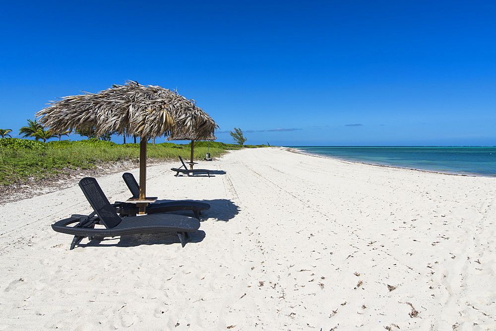 Sun lounger on a white sand beach in northern Providenciales, Turks and Caicos, Caribbean, Central America