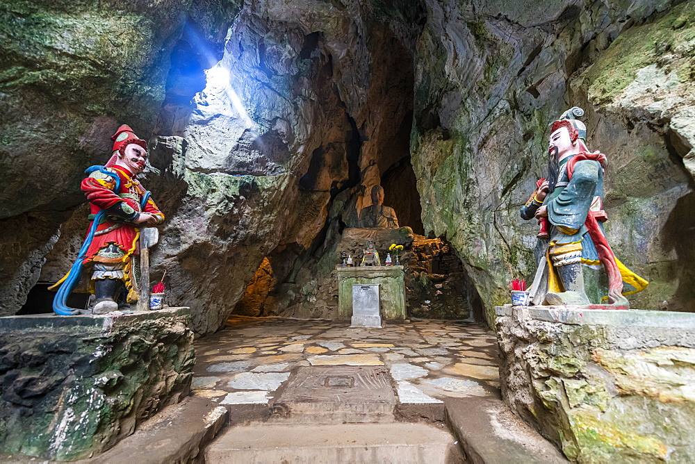 Soldier statues at the entrance to a cave in the Marble 
Mountains, Da Nang, Vietnam, Indochina, Southeast Asia, Asia