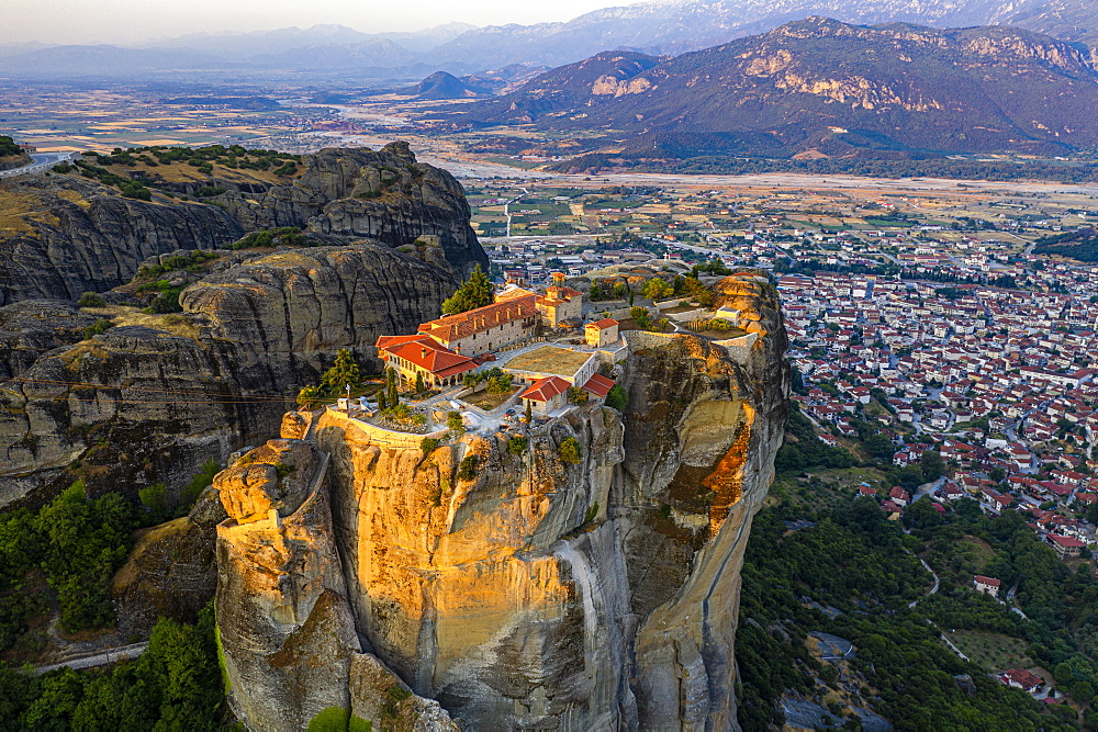 Aerial by drone of the Holy Monastery of Holy Trinity at sunrise, UNESCO World Heritage Site, Meteora Monasteries, Greece, Europe