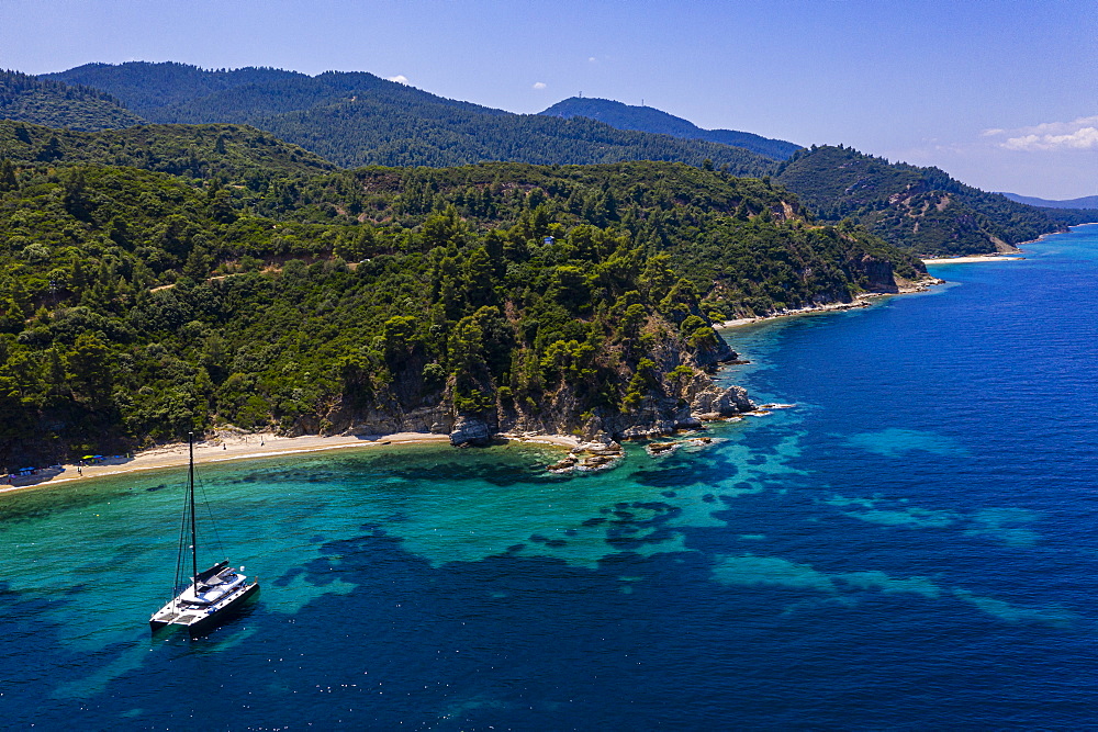 Aerial by drone of a sailing boat on Zografou Beach, Sithonia, Greece, Europe