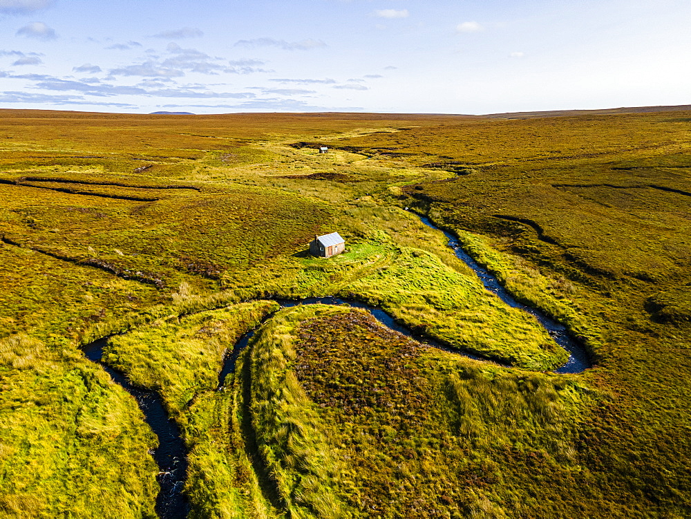 Aerial of a little hut in the Moorland on the Isle of Lewis, Outer Hebrides, Scotland, United Kingdom, Europe