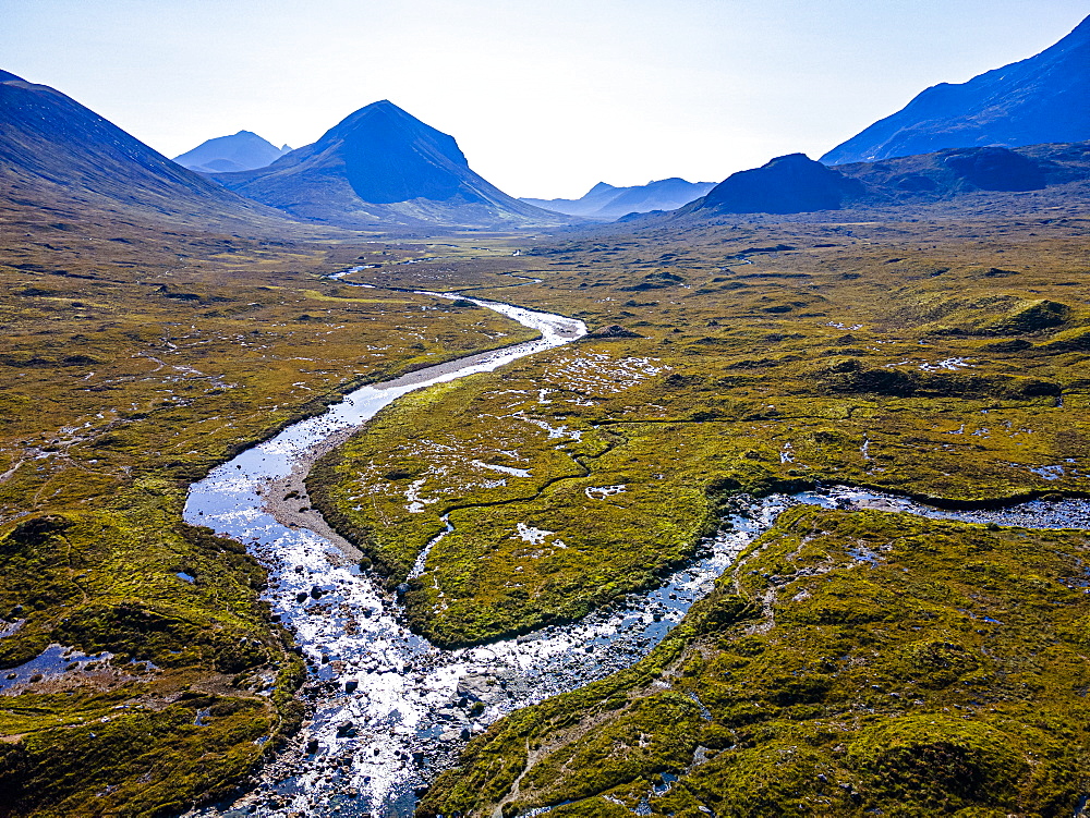 Aerial of a river snaking through the moor of the Black Cuillin ridge, Isle of Skye, Inner Hebrides, Scotland, United Kingdom, Europe