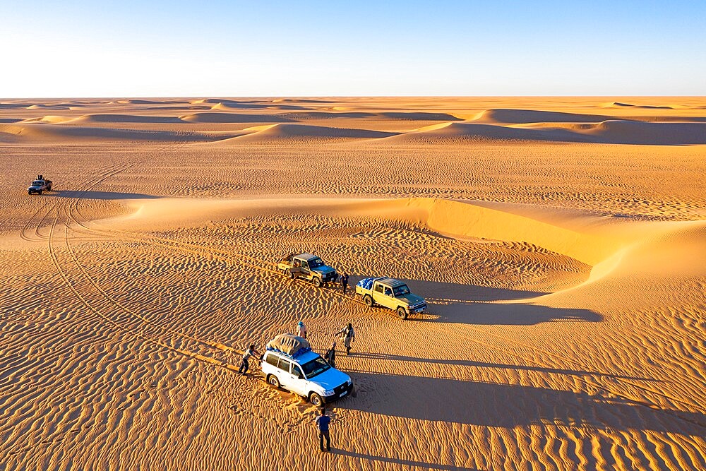 Aerials of cars driving through the sand dunes of the Tenere Desert, Sahara, Niger, Africa