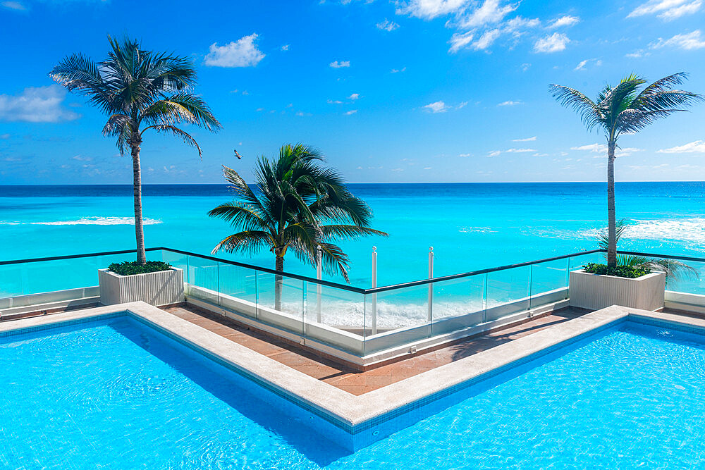 Swimming pool over the turquoise waters of Cancun, Quintana Roo, Mexico, North America