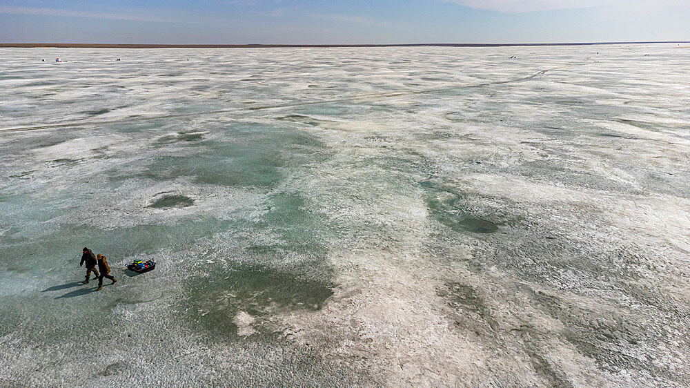 Aerial of fisherman walking on Lake Tengiz, Korgalzhyn Nature Reserve, Saryarka, Steppe and Lakes of Northern Kazakhstan, UNESCO World Heritage Site, Kazakhstan, Central Asia, Asia