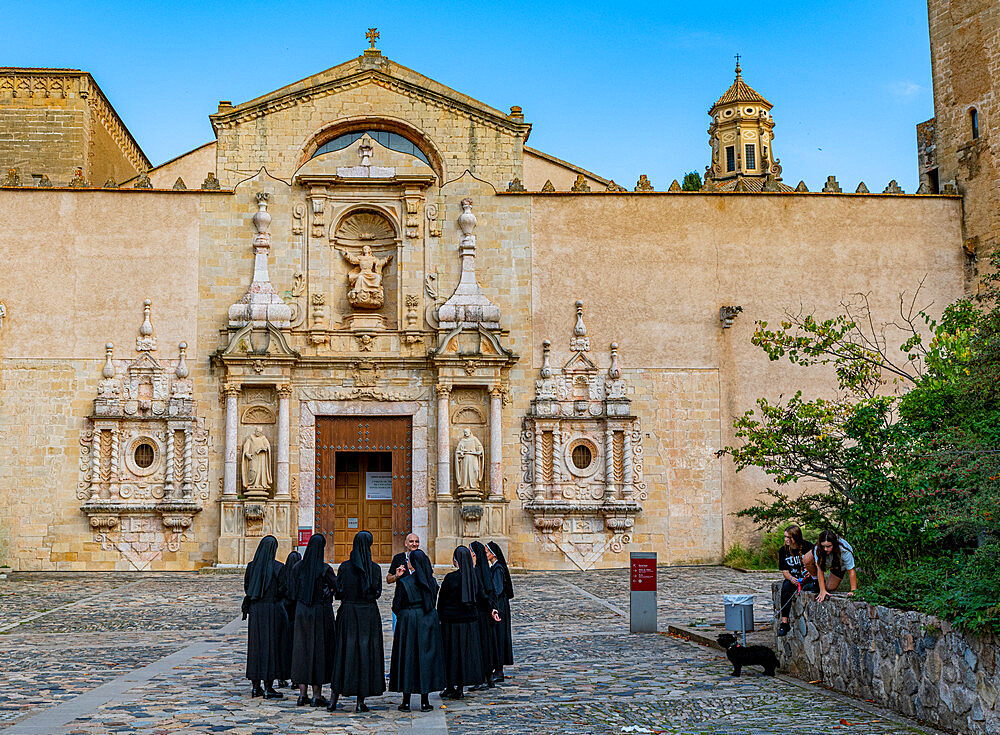 Nuns in front of the main portal of the church, Poblet Abbey, UNESCO World Heritage Site, Catalonia, Spain, Europe