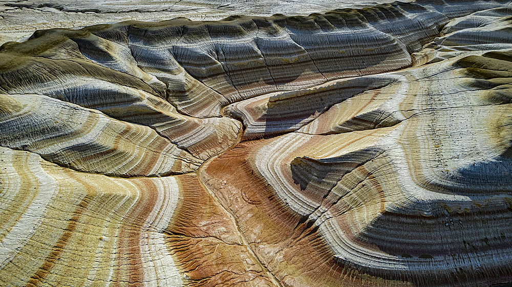 Aerial of multicoloured layers of sandstone, Kyzylkup, Mangystau, Kazakhstan