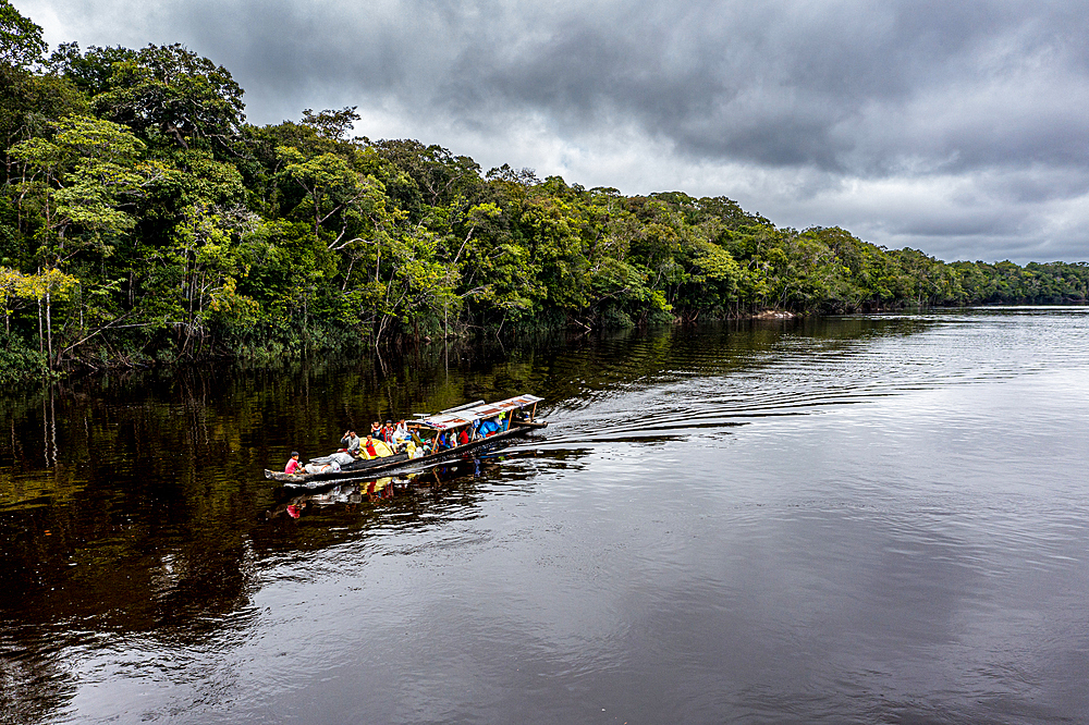 Illegal miners on their boat on the black Pasimoni River, in the deep south of Venezuela, South America