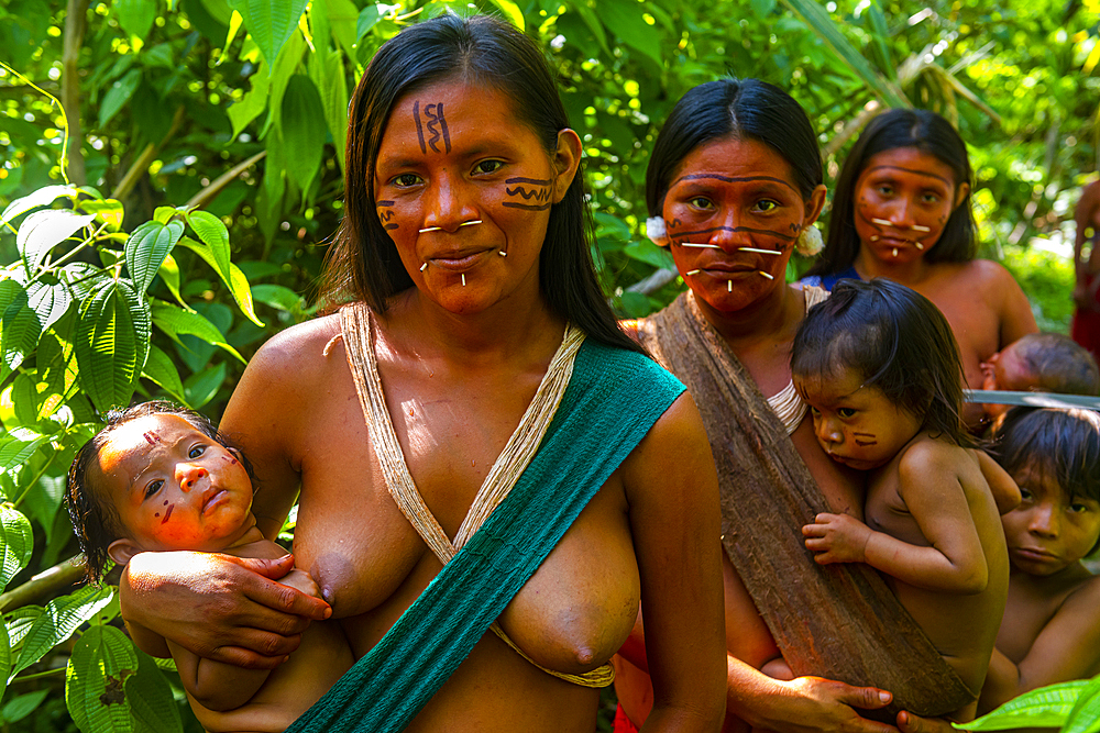 Women with their babies from the Yanomami tribe standing in the jungle, southern Venezuela, South America