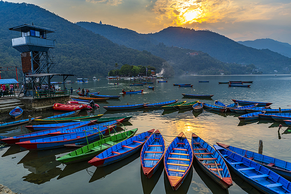 Sunset over Fewa Lake with many rowing boats, Pokhara, Nepal, Asia