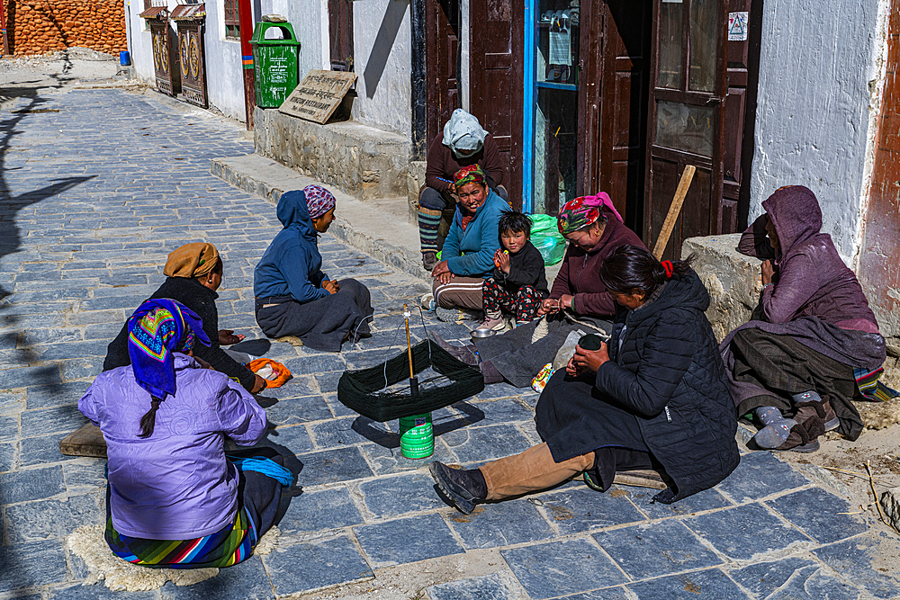 Local women practising traditional weaving in Lo-Manthang village, Kingdom of Mustang, Himalayas, Nepal, Asia