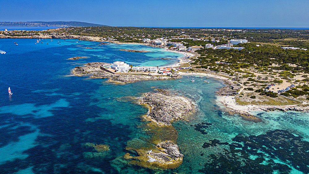 Aerial of the turquoise waters and white sand beach of the Pujols beach, Formentera, Balearic Islands, Spain, Mediterranean, Europe