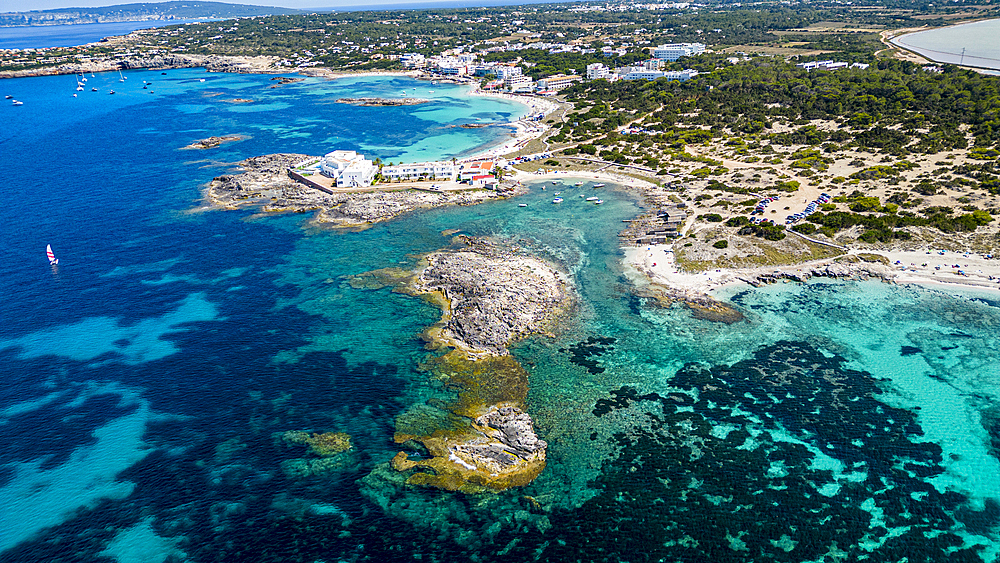 Aerial of the turquoise waters and white sand beach of the Pujols beach, Formentera, Balearic Islands, Spain, Mediterranean, Europe