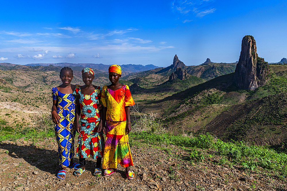 Three Kapsiki tribal girls in front of the lunar landscape, Rhumsiki, Mandara mountains, Far North province, Cameroon, Africa