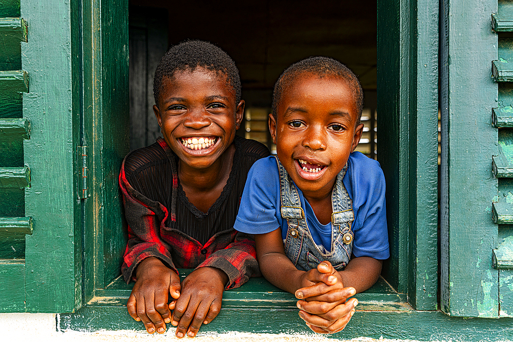 Young school kids looking out from a window, Ciudad de la Paz, Rio Muni, Equatorial Guinea, Africa