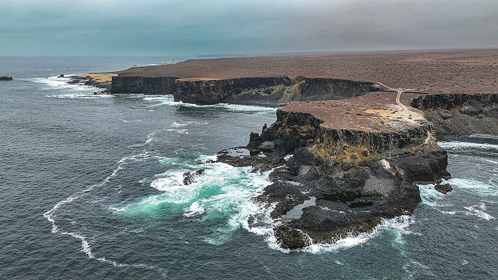 Aerial of the wild coastline with basalt pools on the Atlantic coastline, Dombe Grande, Namibre, Angola, Africa