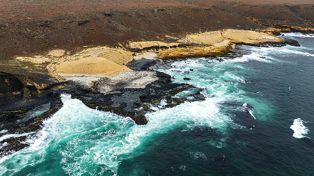 Aerial of the wild coastline with basalt pools on the Atlantic coastline, Dombe Grande, Namibre, Angola, Africa