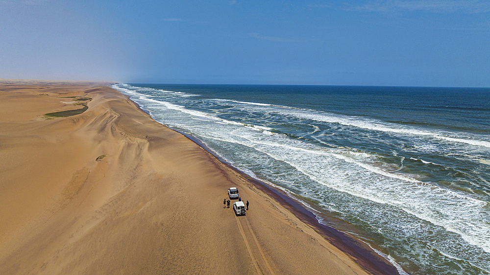 Cars driving on the ridge of the sanddunes along the Atlantic, Namibe (Namib) desert, Iona National Park, Namibe, Angola, Africa