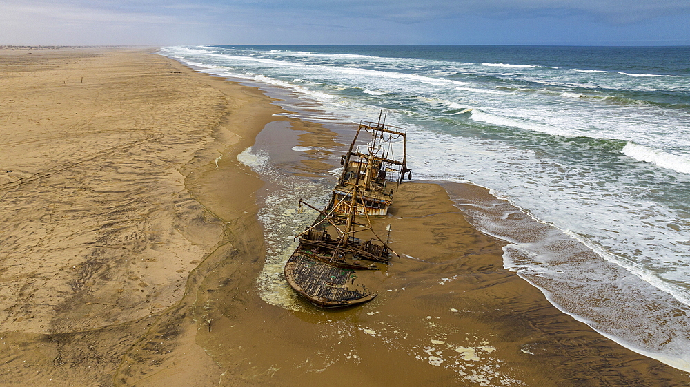 Aerial of a shipwreck on a beach in the Iona National Park, Namibe, Angola, Africa