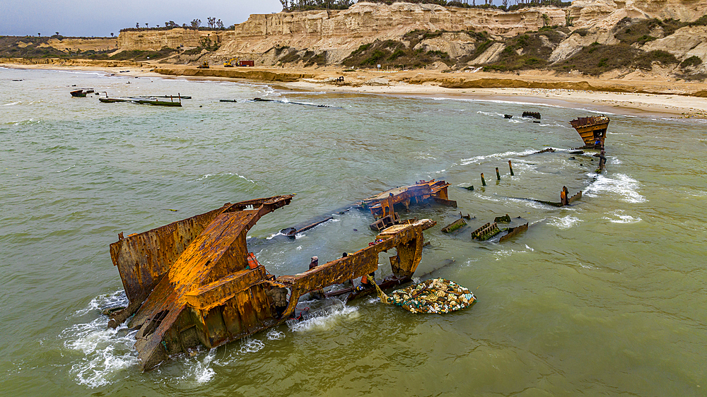 Men dismantling a boat on Shipwreck beach, Bay of Santiago, Luanda, Angola, Africa