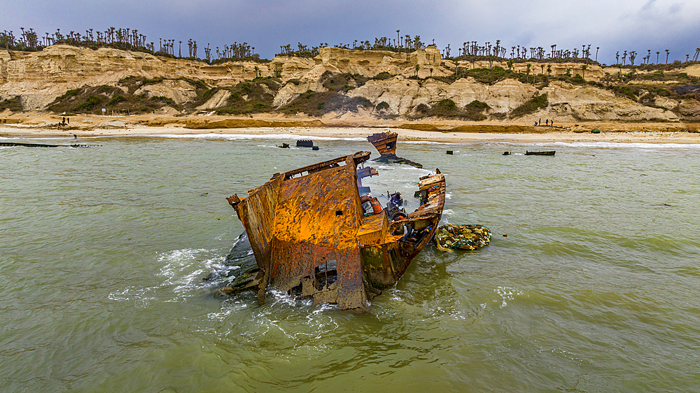 Men dismantling a boat on Shipwreck beach, Bay of Santiago, Luanda, Angola, Africa