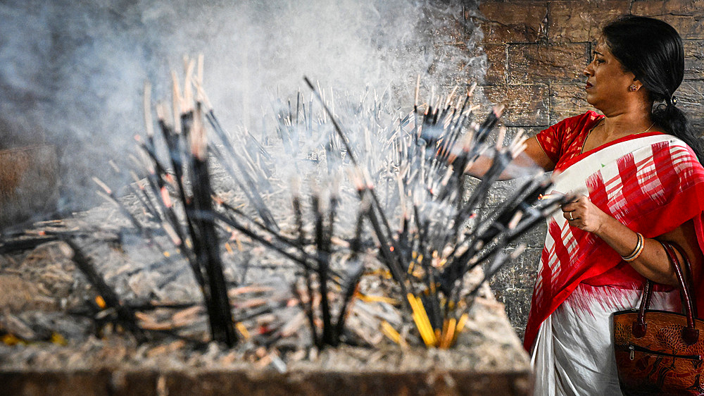 Woman devotee with incense sticks, Kamakhya Temple, Guwahati, Assam, India, Asia