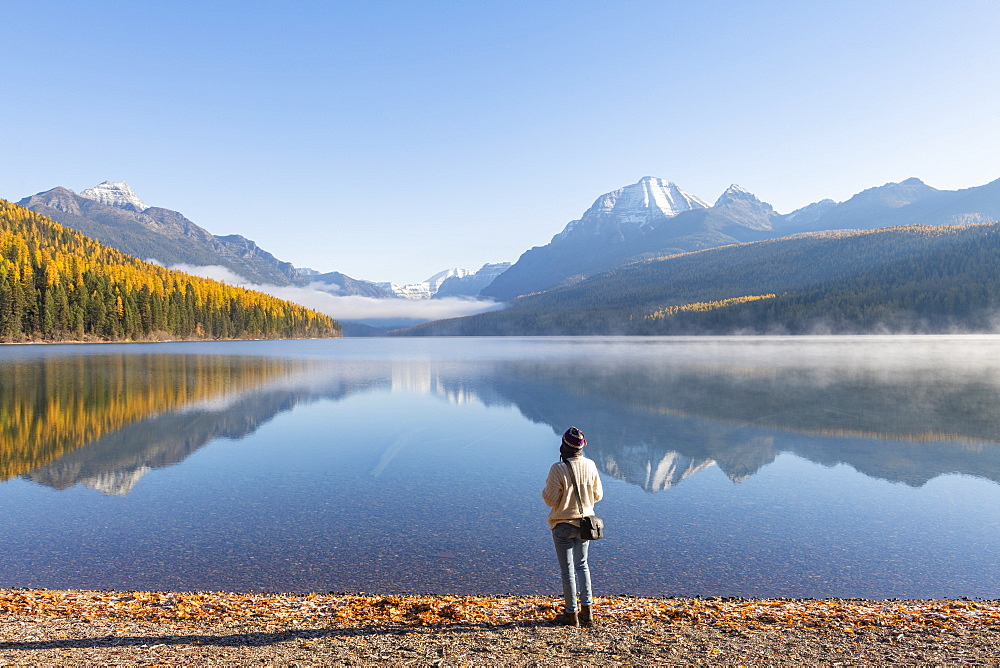 Woman on the shores of Bowman Lake, Glacier National Park, Montana, United States of America, North America