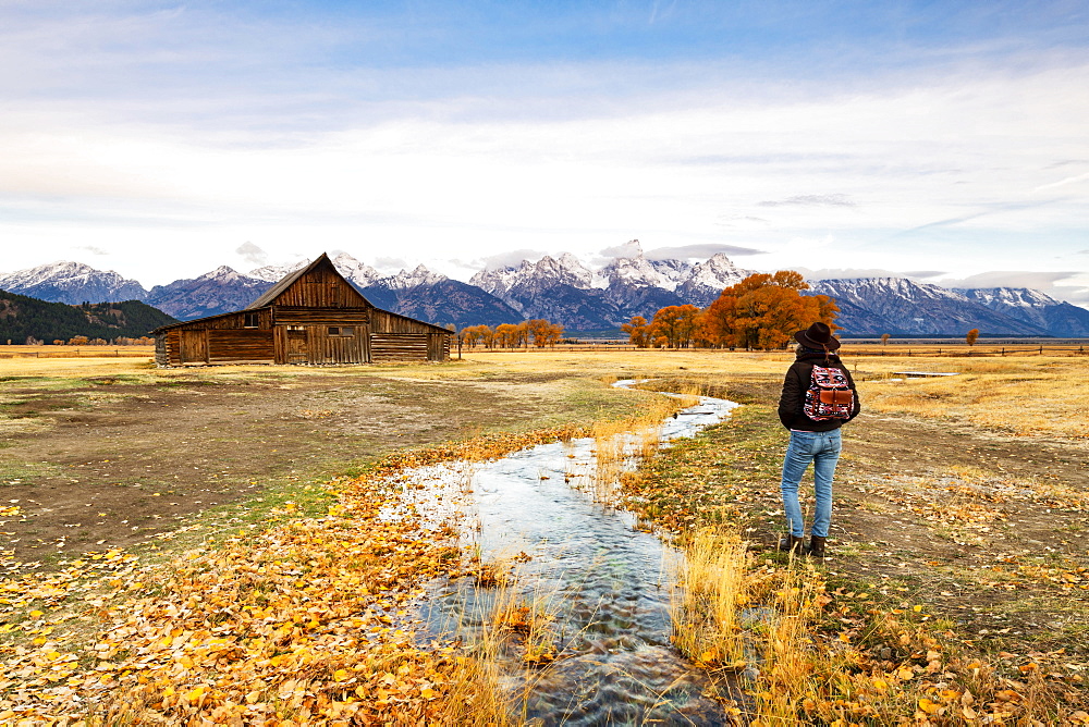 Woman at Mormon Row and Teton Range, Grand Teton National Park, Wyoming, United States of America, North America