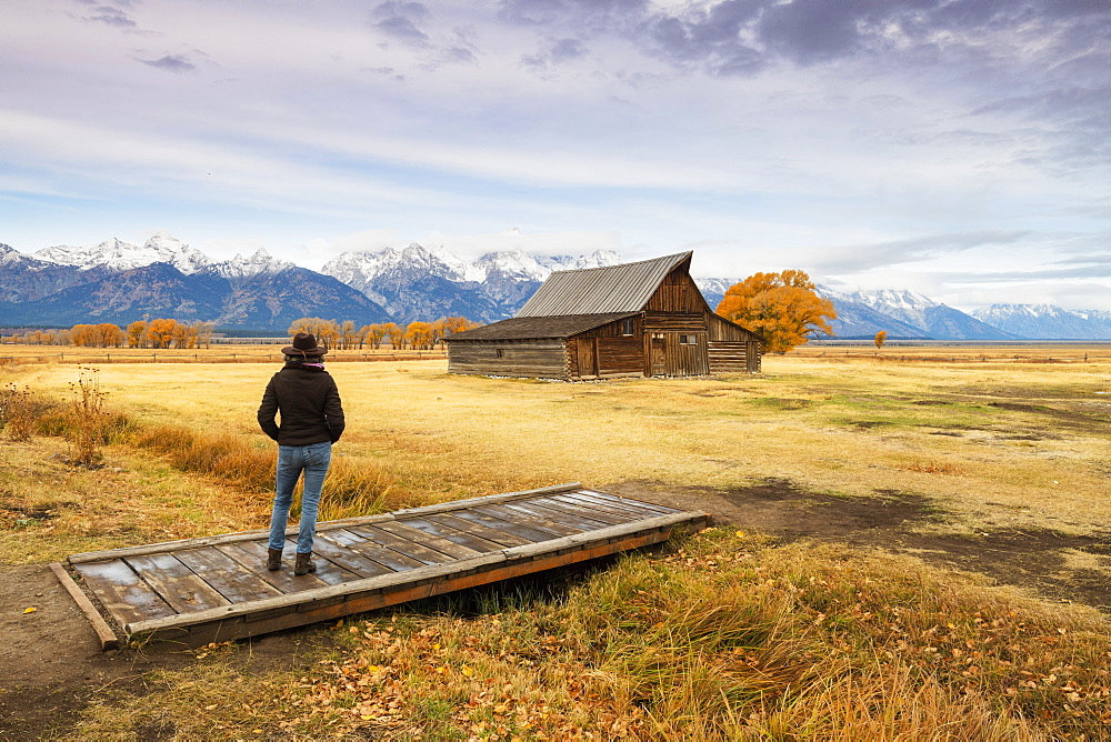 Woman at Mormon Row and Teton Range, Grand Teton National Park, Wyoming, United States of America, North America