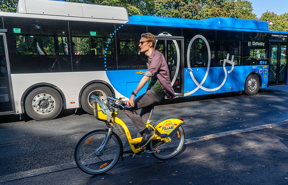 Young cyclist by tram in a street in Helsinki ,Finland, Europe