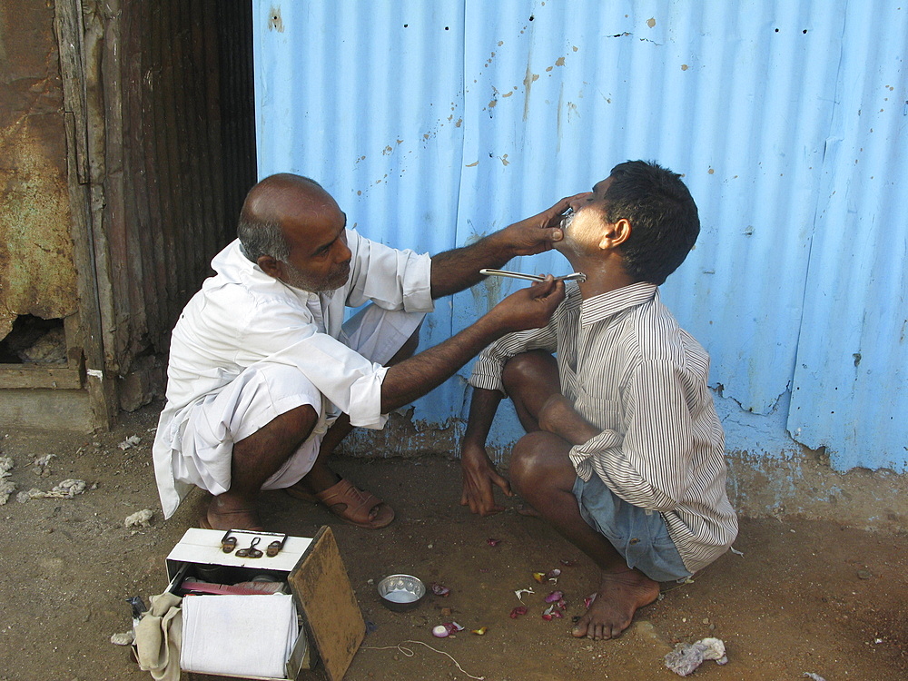 India. Barber in streets of colaba, mumbai