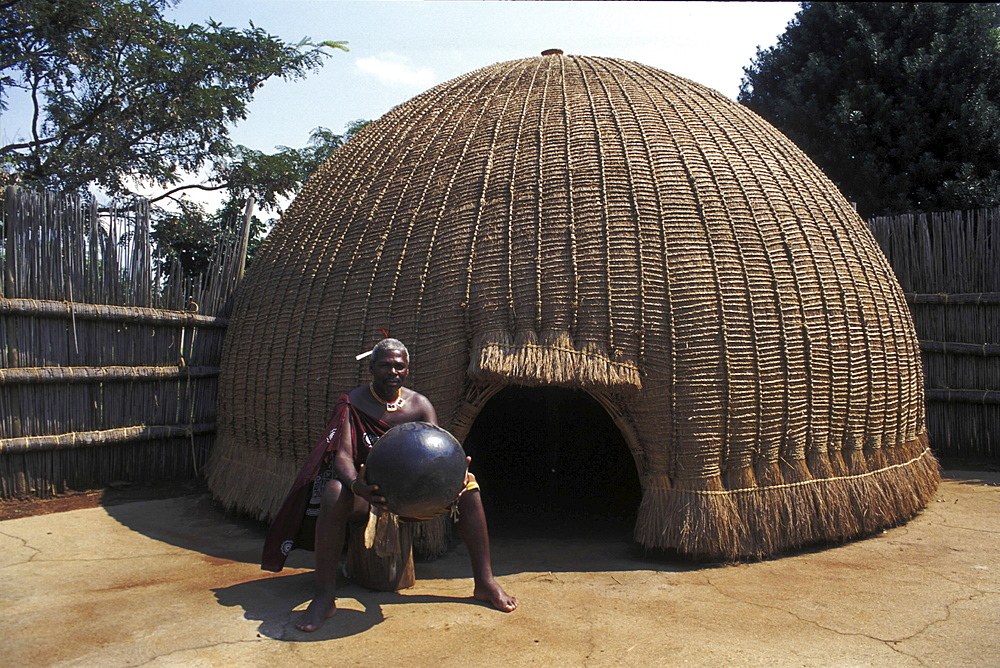 Indigenous people, swaziland. Swazi medicine man outside his village hut