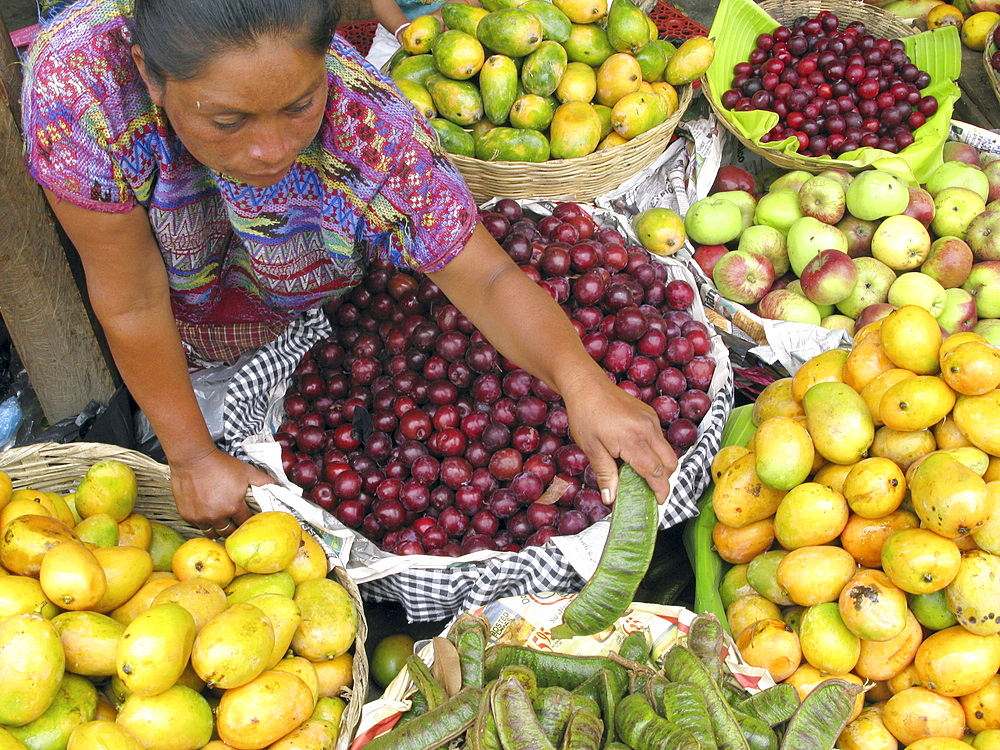 Guatemala native quiche woman selling fruit in a market place in guatemala city