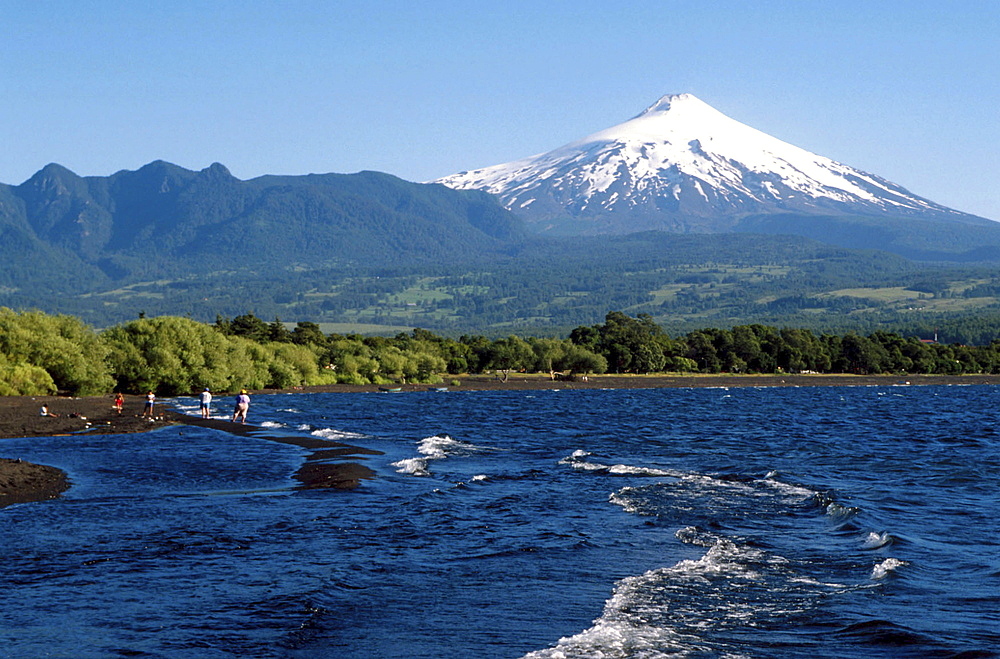 Chile, tourists visiting the osorno volcano and lake in the southern region.