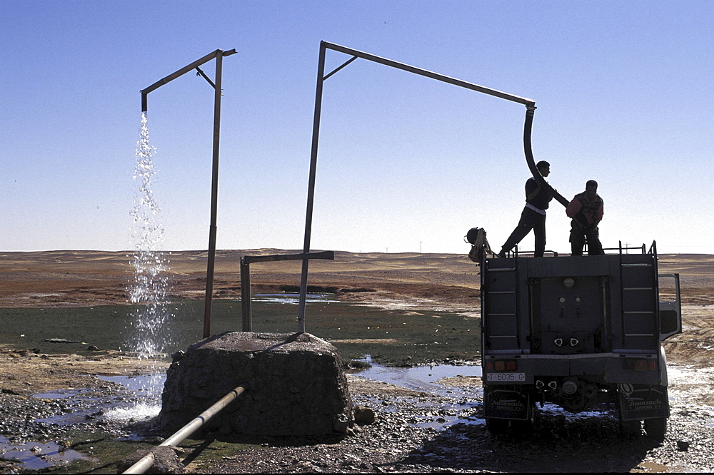 Refugee camp, algeria. Lorries loading water from main pipe at polisario central camp