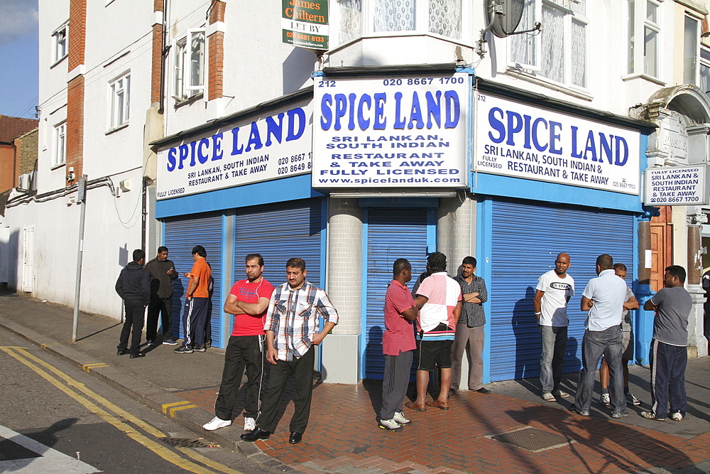 Local residents watch damage to property after riots and looting in Croydon, London, UK ;