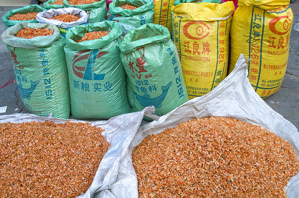 China merchants packing dry shrimps, a local delicacy, in the old quarter in guangzhou, guangdong province