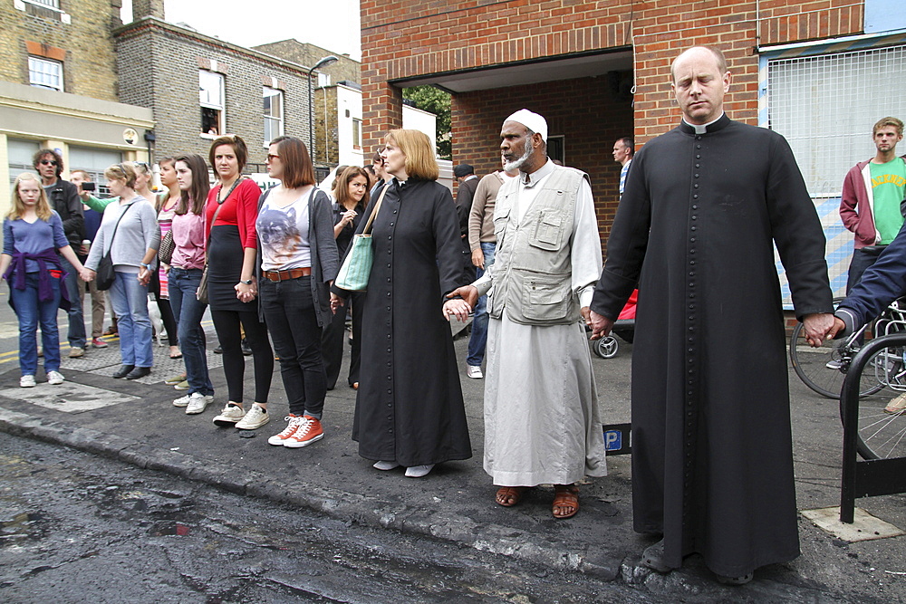 Local community get together to clear damage caused by rioters in Hackney, London, UK ;