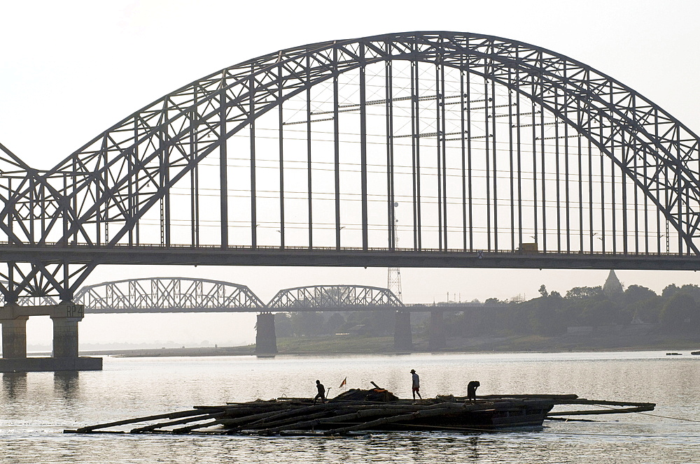 Myanmar (burma) sunset at mandalay harbour with bridges on background on the irrawady river near sagaing, mandalay